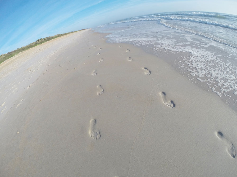 Footsteps in the sand along a beach walk during our St. Augustine weekend getaway