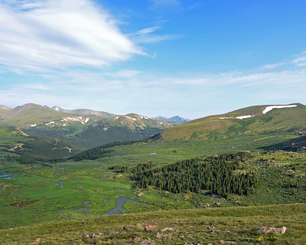 View into the valley full of green while hiking Mt. Bierstadt