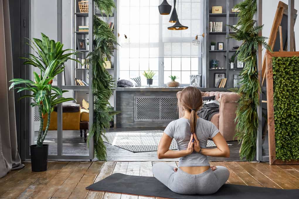 girl practicing ashtanga yoga bind with hands in reverse prayer