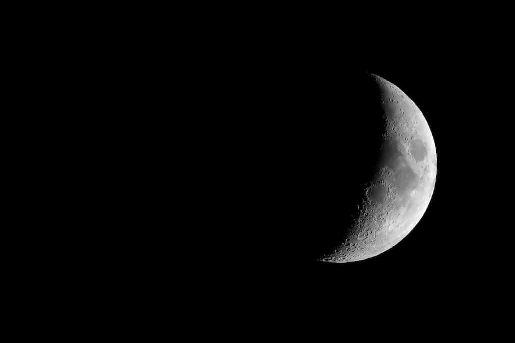 Waxing crescent moon seen with an astronomical telescope, 3:2 format in black and white