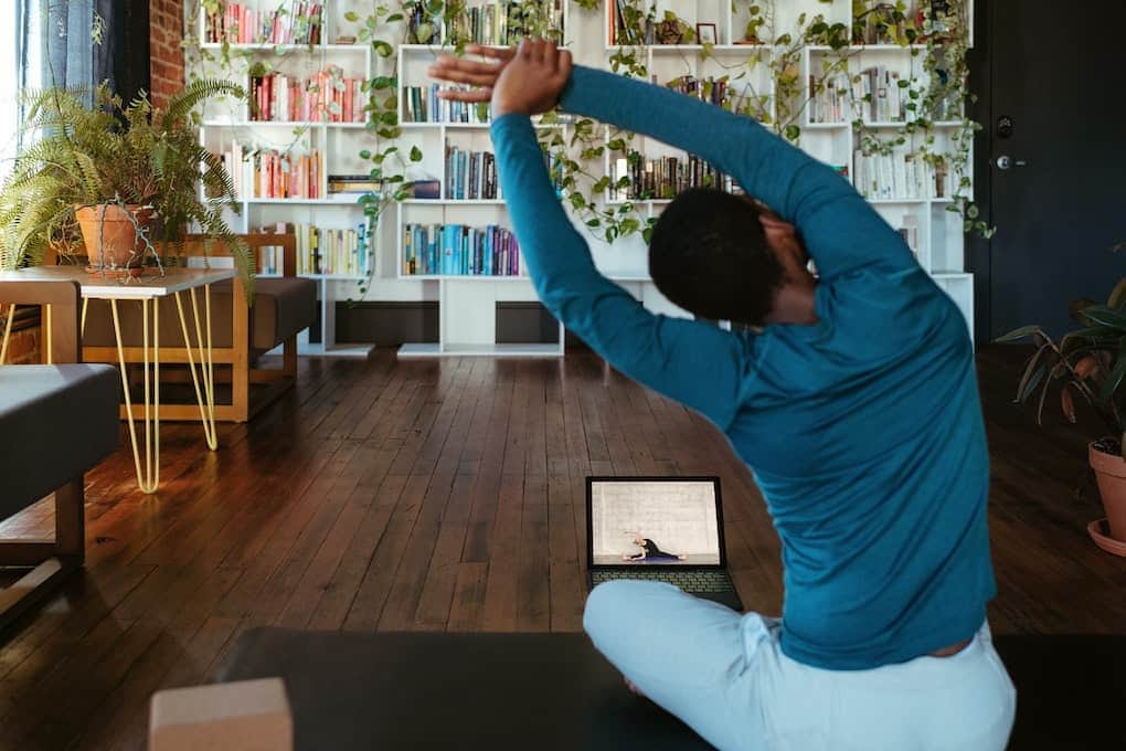 person practicing home yoga online