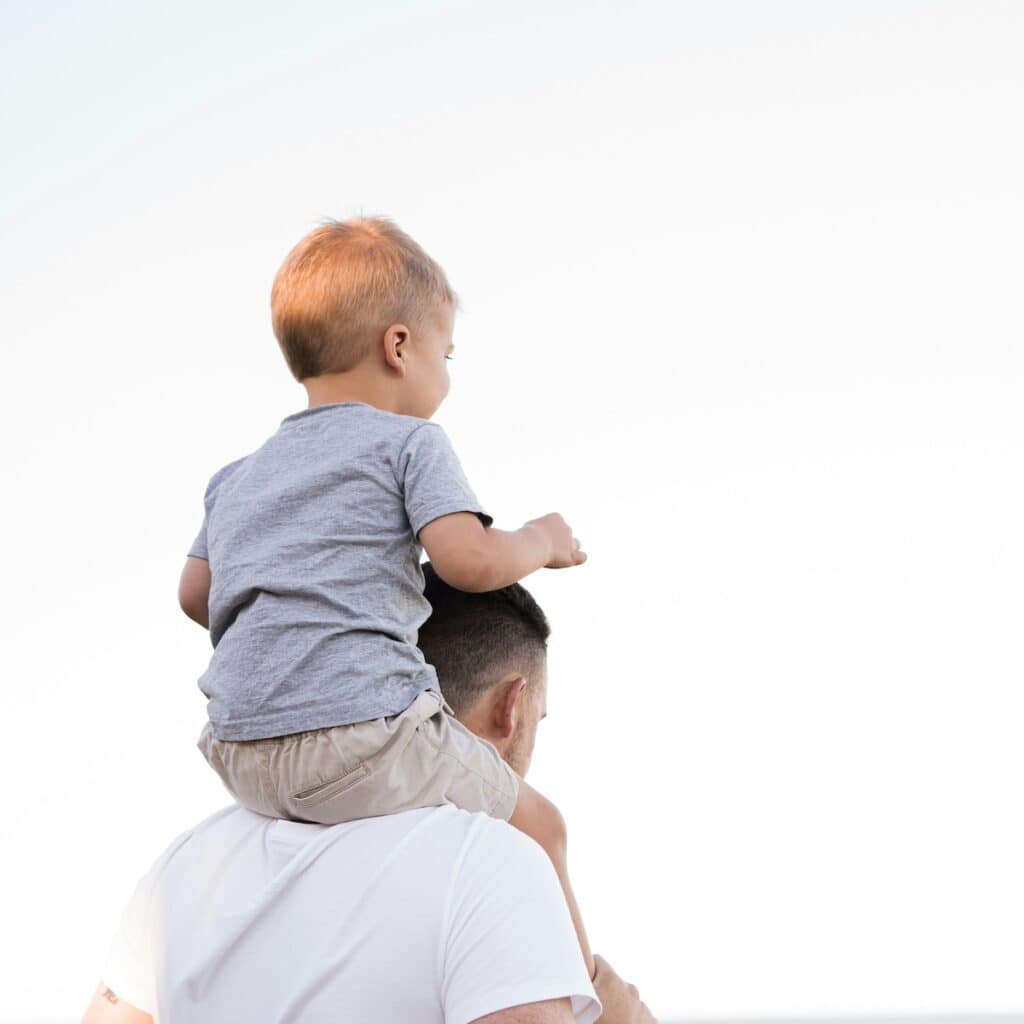father with son on shoulders, "mini me" representing inner child