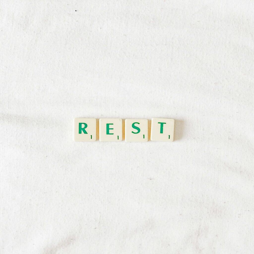 scrabble letters spelling out the word "rest"
