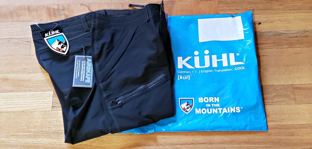 Folded KÜHL JetStream™ Rain Pants with tags and plastic shipping bag