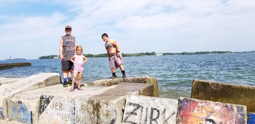 kids on rocks in front of Lake Erie