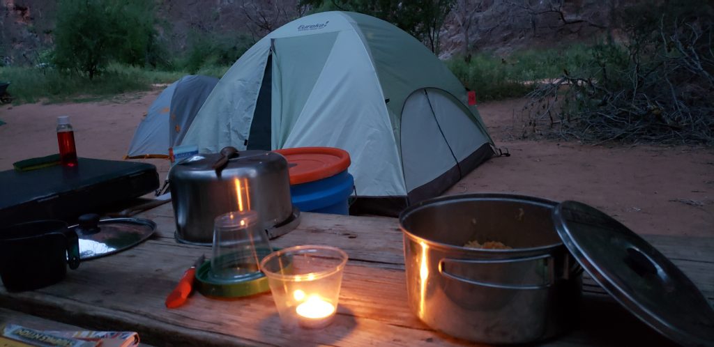 Picnic table with candle - tent in background