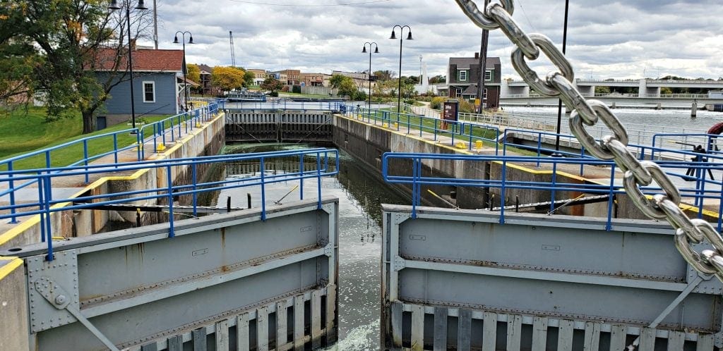 huge gray metal doors sit partially opened to the lock at De Pere Riverwalk, one of the things to do in Green Bay WI