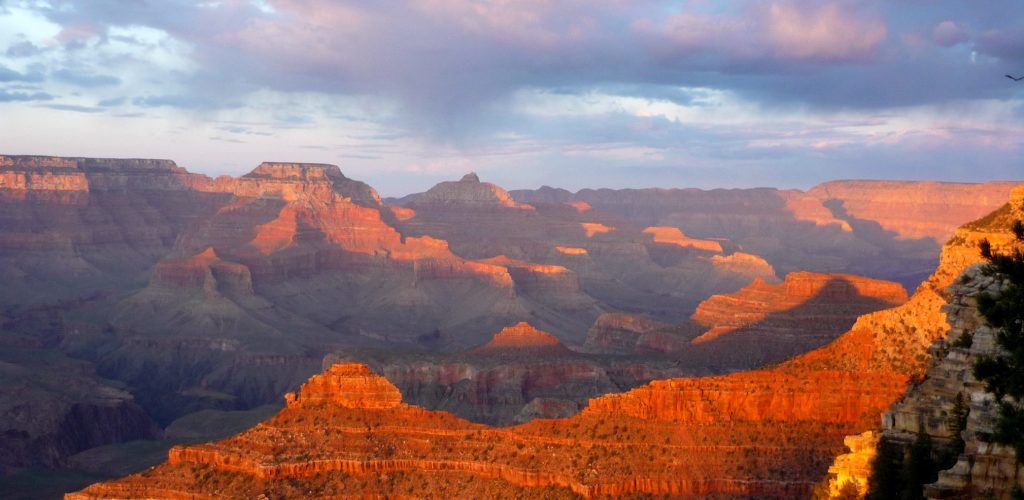 looking into the Grand Canyon from a South Rim viewpoint at sunset