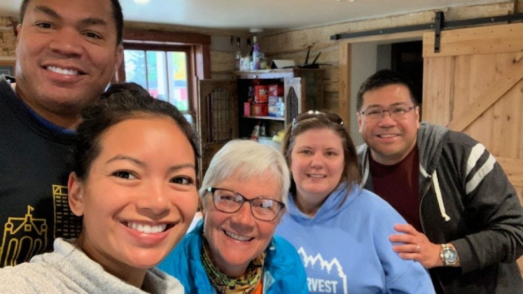 5 people smile for a selfie in the Paluso Guest Ranch kitchen on the WI oilgrimage