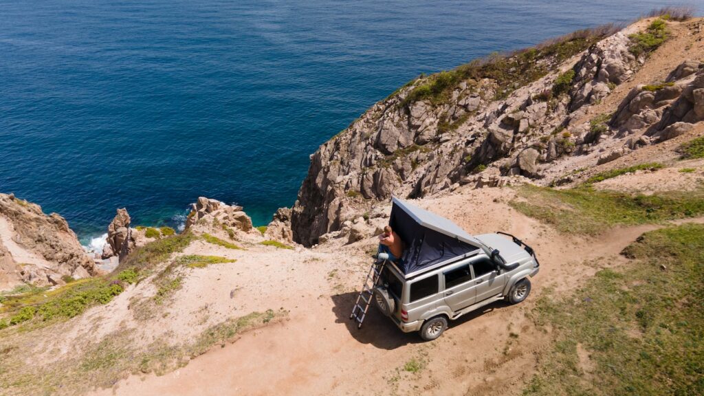 Man sitting in a roof top tent