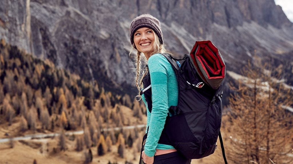 young woman backpacking in mountains
