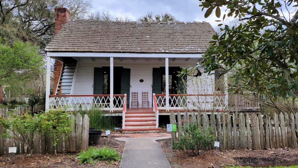 Touring this small historic house with front porch, door in center and two windows on each side is one of the things to do in Lafayette LA