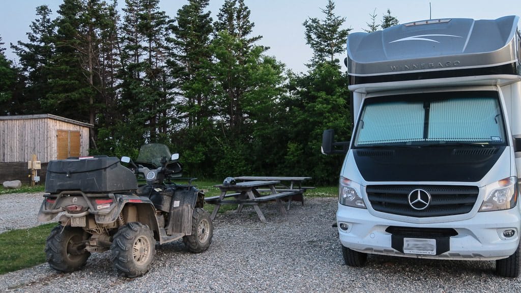 Our Winnebago View with an ATV parked out front for our sunset adventures