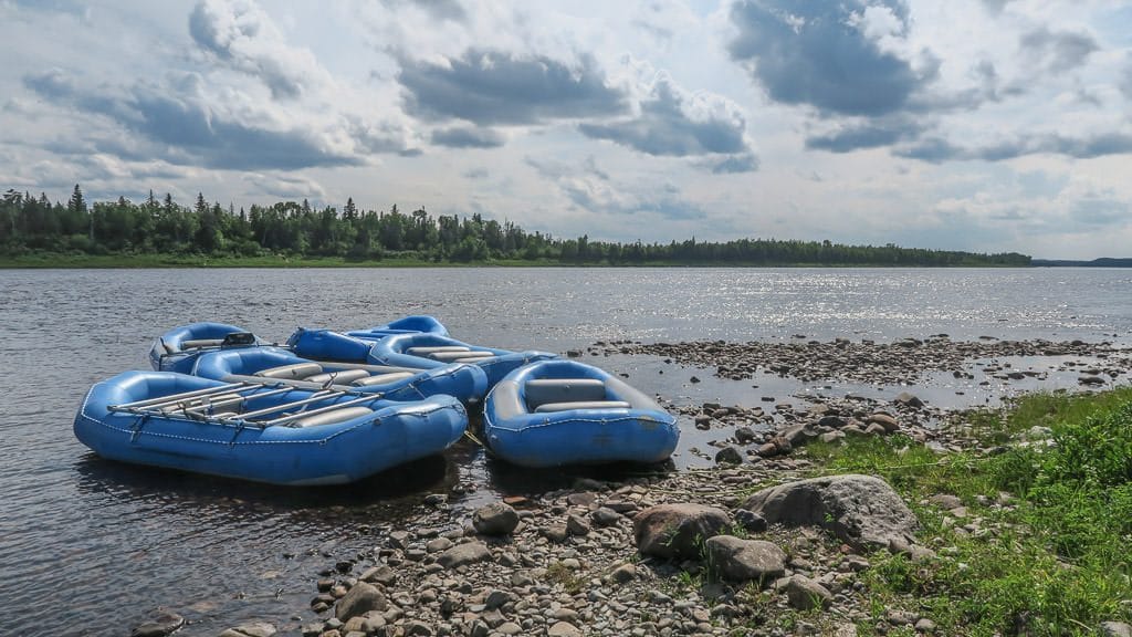 White water rafting rafts sitting on the edge of the Exploits River