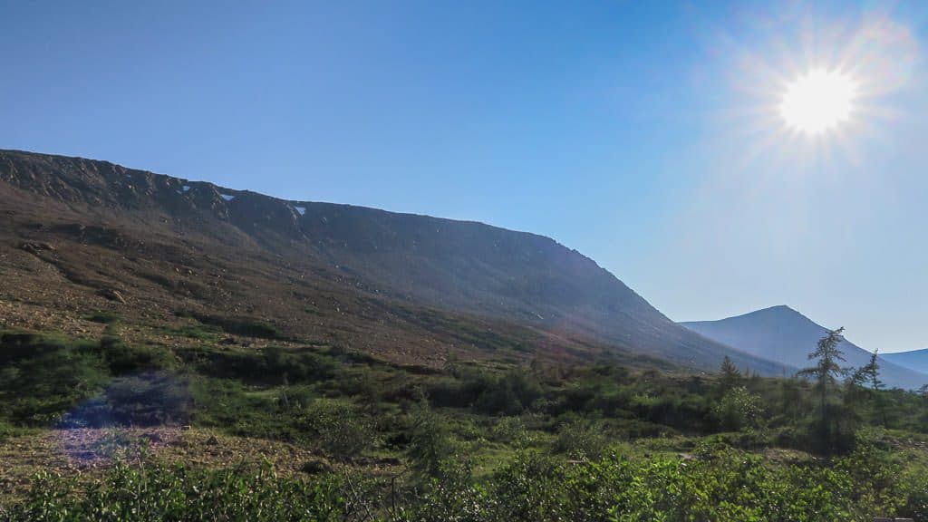 Sun shining brightly over a lush green area near Tablelands