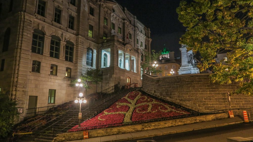 Beautiful designed garden area bext to historic building and stairs in Quebec City