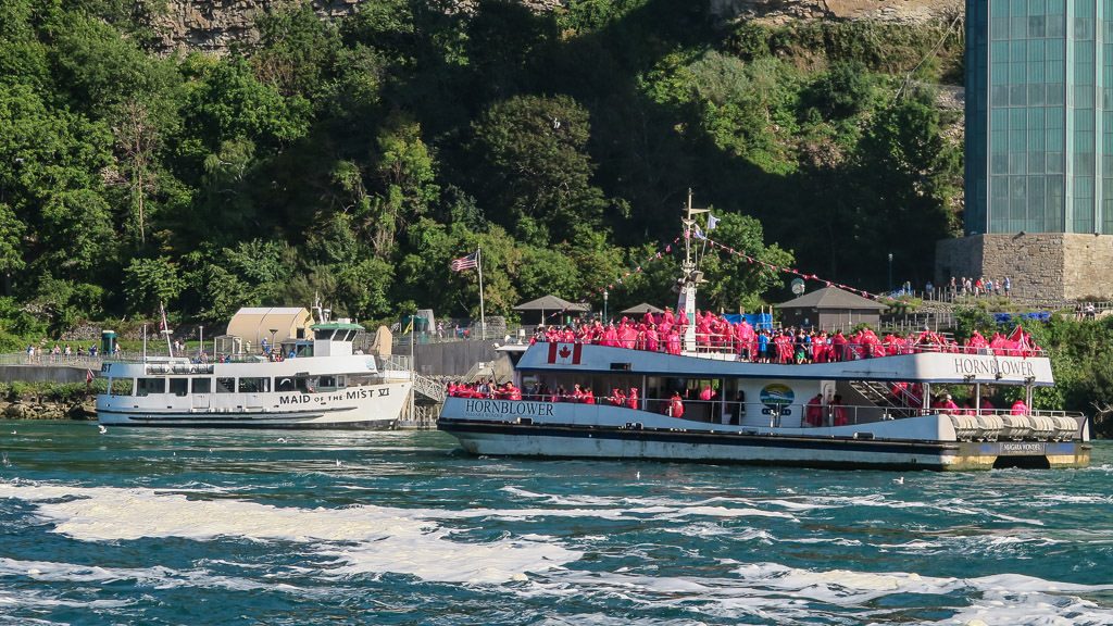 Hornblower Niagara Cruise boat next to the American version Maid of the Mist