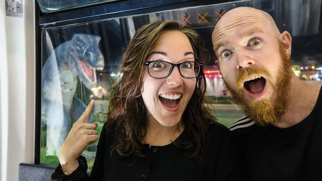 Brooke and Buddy posing next to a T-Rex at the putt putt course at Clifton Hill in Niagara Falls, Ontario