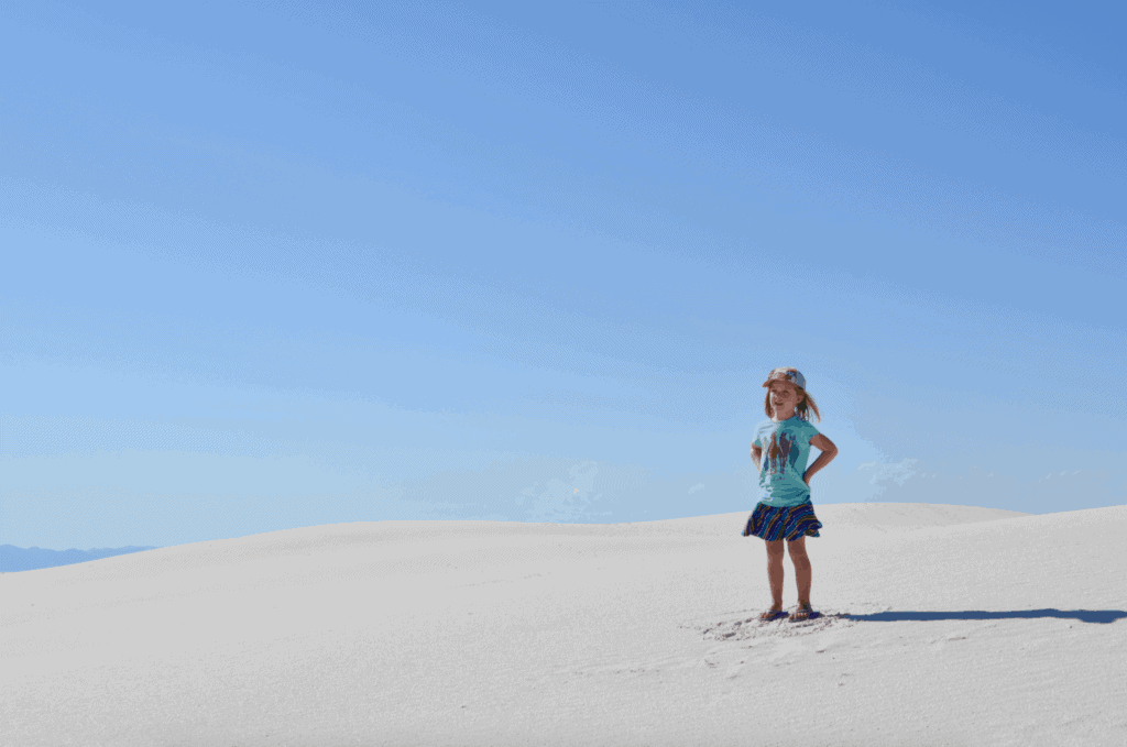 girl standing in white sand