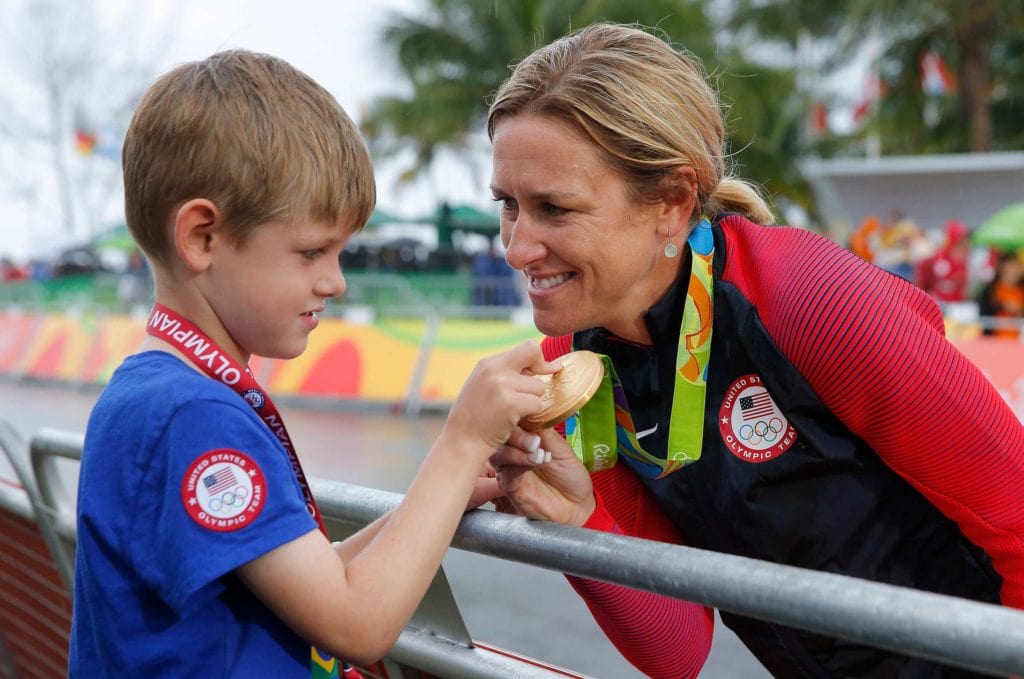 Kristin Armstrong with her son enjoying the spoils of her gold medal ride.