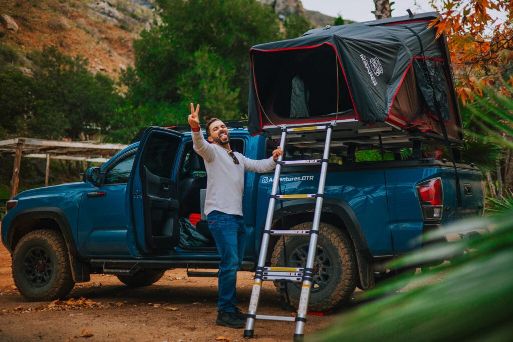 man in front of rooftop tent