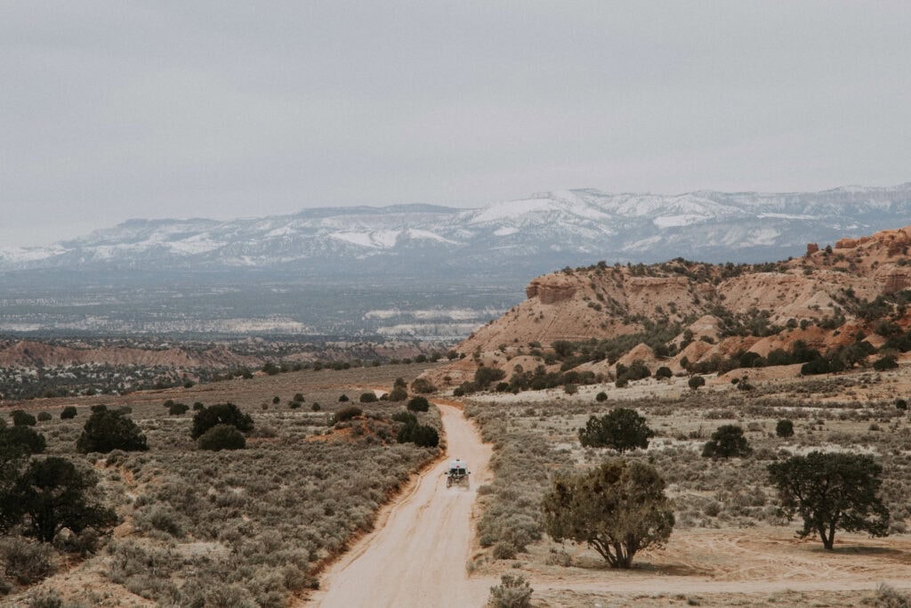 4x4 converted Ford e350 driving through the backcountry in Escalante, Utah