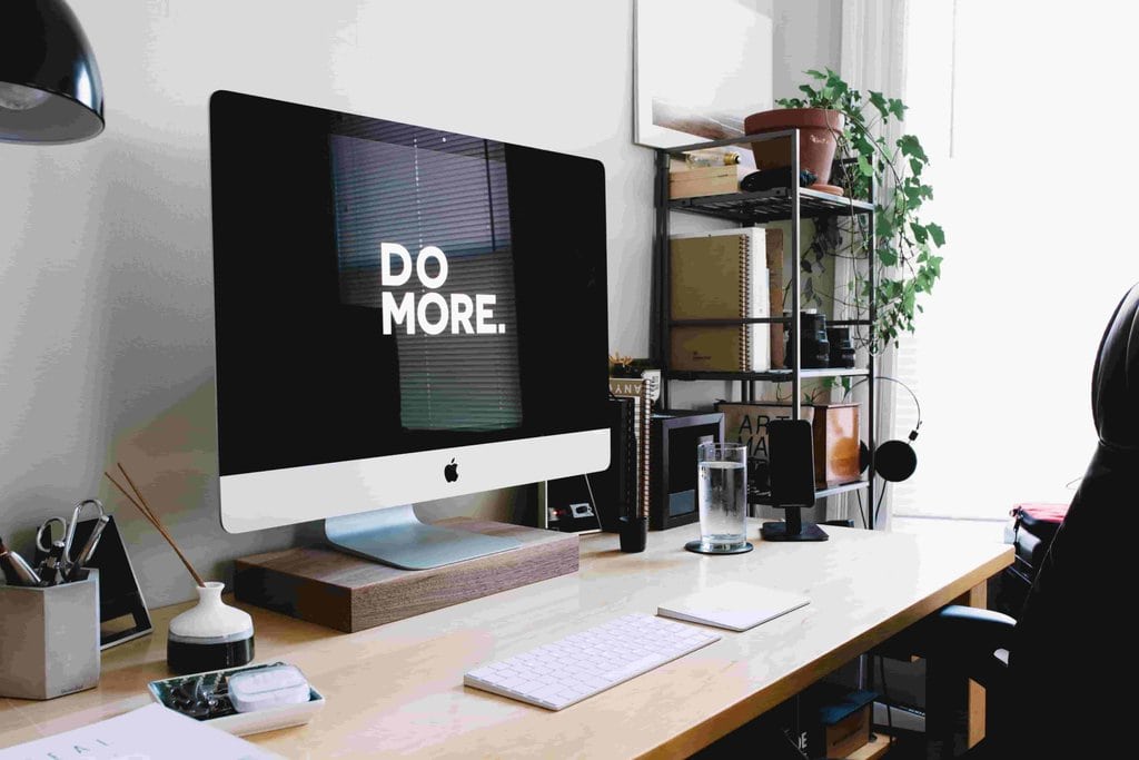 A monitor at workdesk saying "Do More"