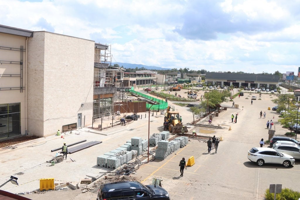 Elevated view of a mall exterior and parking area during construction