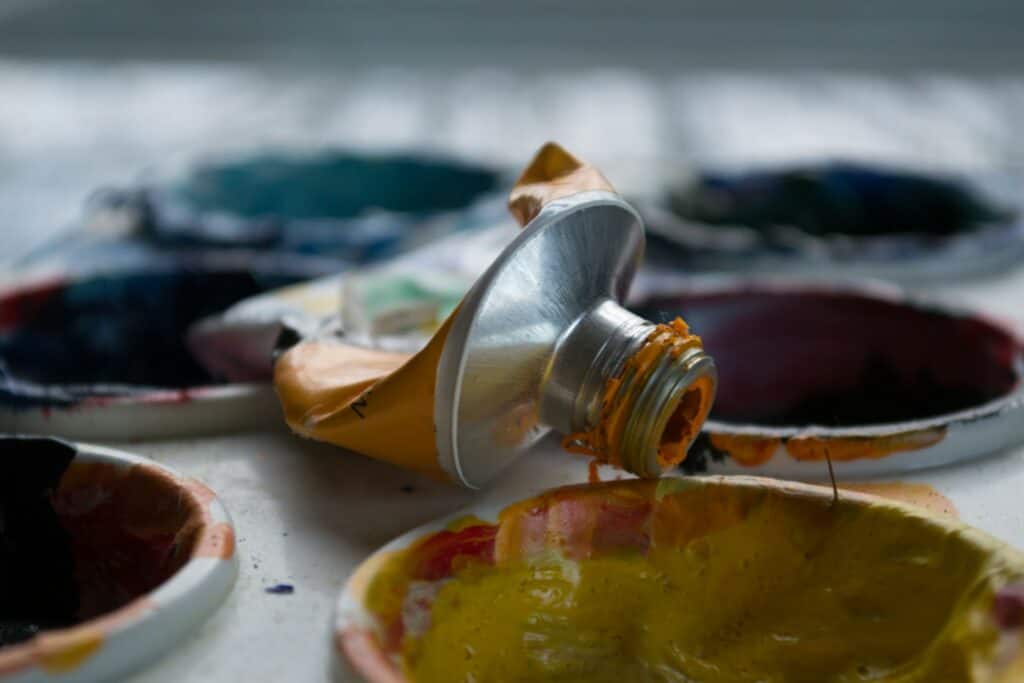 tube of paint emptying into cup