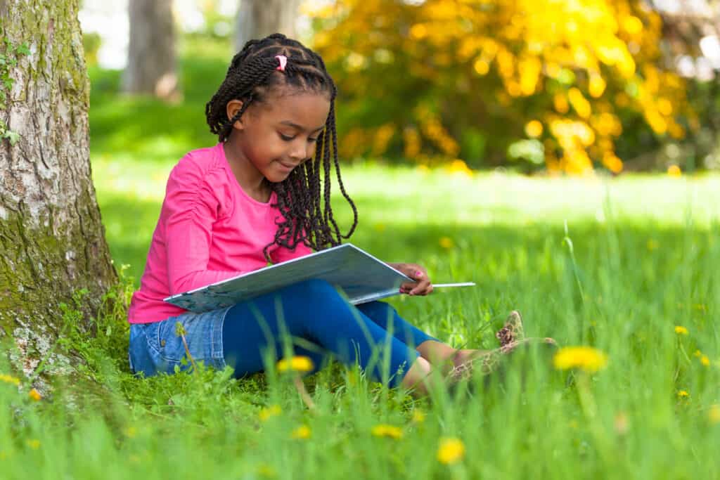 summer reading - girl reading on the grass