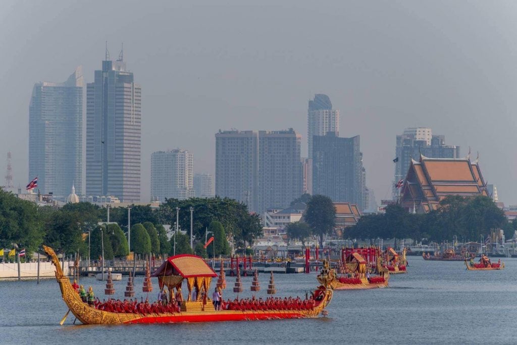 Gilded long boat with 60 oarsmen paddle on the river for part of the Thai Royal Barge Processional