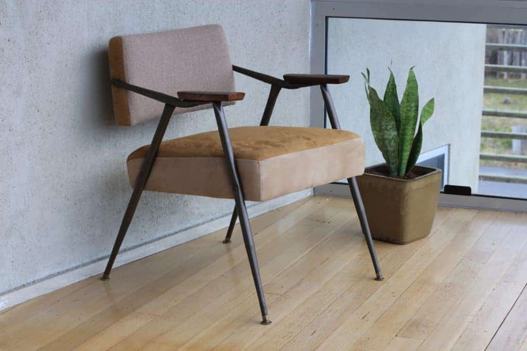 Little Spaces - Midcentury modern brown chair next to low window and plant.