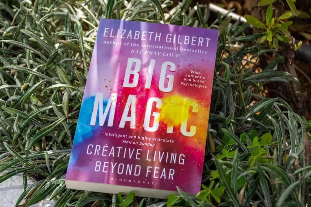 Elizabeth Gilbert big magic - creative living beyond fear spiritual book pictured on grass