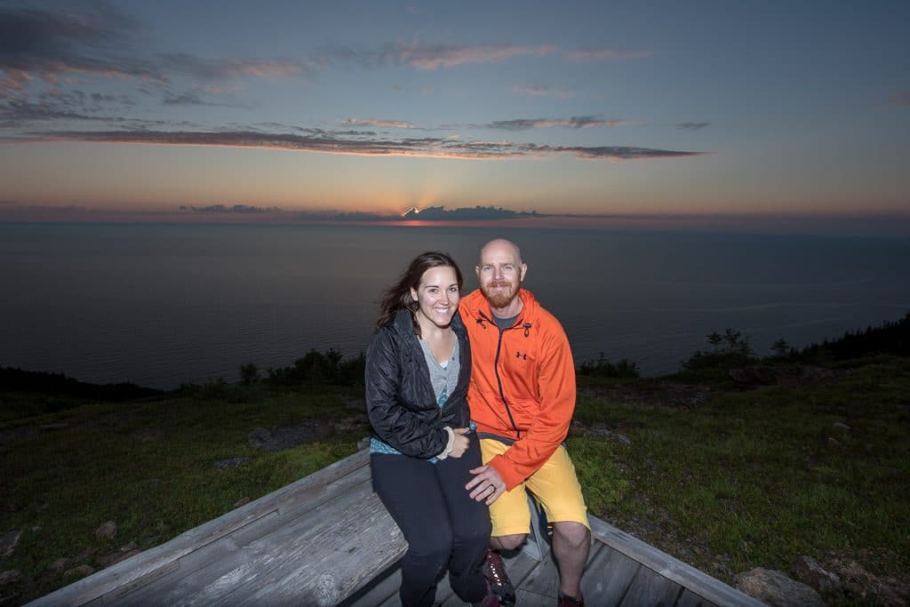 Brooke and Buddy sitting at the end of Skyline Trail at sunset