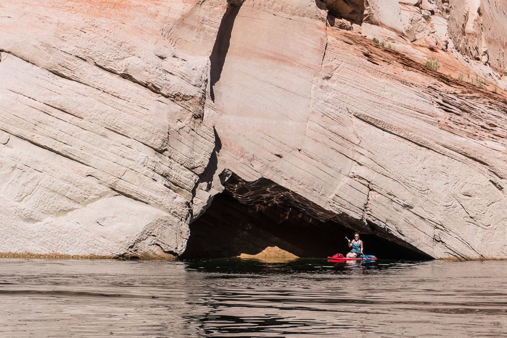 Brooke on her paddleboard in a mini cave we found while paddleboarding on Lake Powell