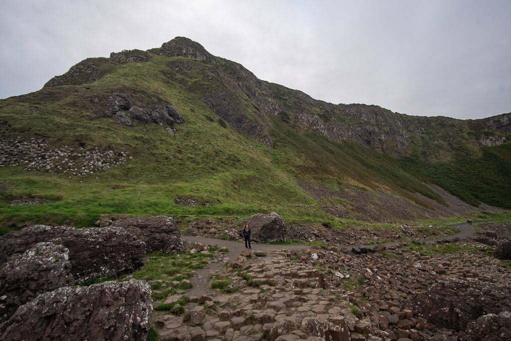 Brooke walking around giants causeway in Northern Ireland during our 5-day Ireland road trip