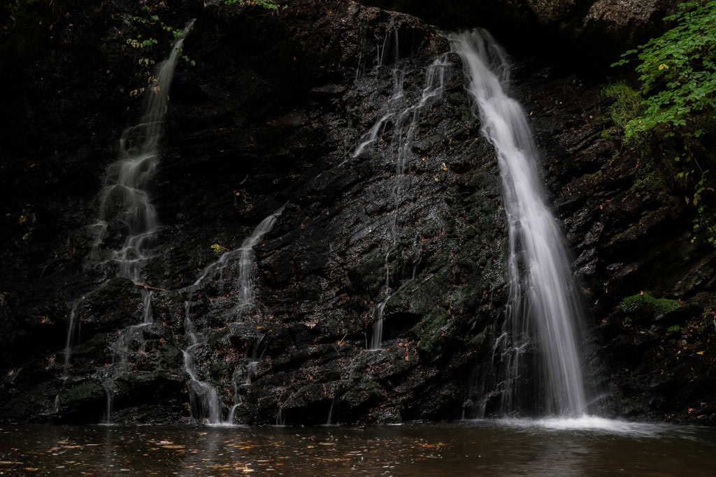 The first waterfall you get to at Fairy Glen Falls, which is multi-tiered and flowing over black rocks