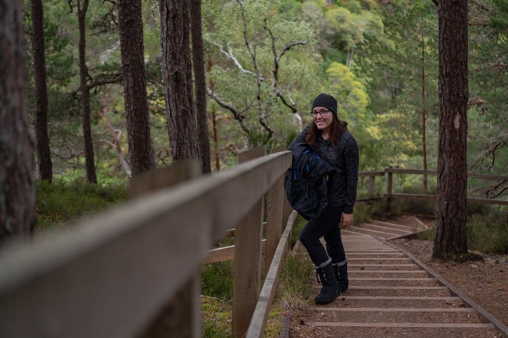 Brooke standing on some of the stairs on a section of the trail leading to Falls of Foyers