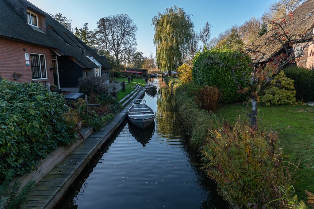 house with boat on canal in giethoorne on day trips from amsterdam