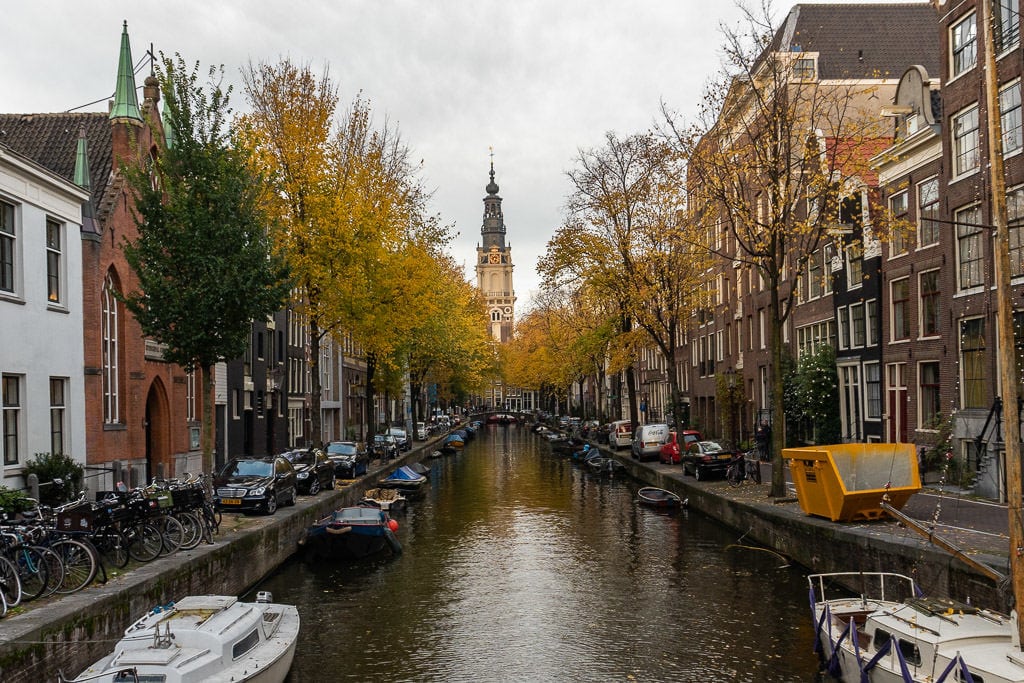 amsterdam canal with spire views and bicycles