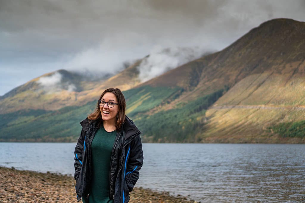 Brooke standing next to the lake across from Corriegour Lodge