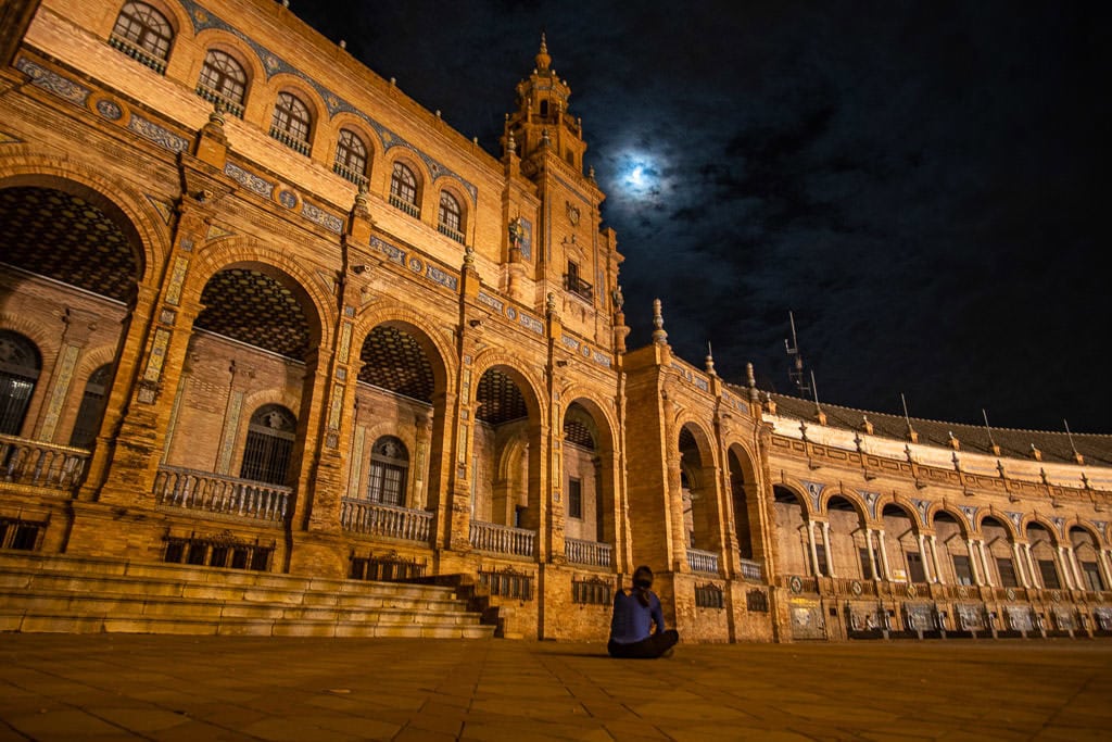 looking up at moon at the plaza de espana in seville at night