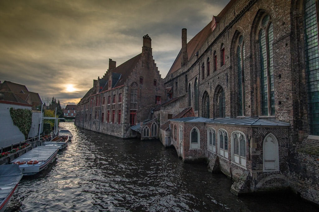 canal scene with brick buildings in bruges belgium