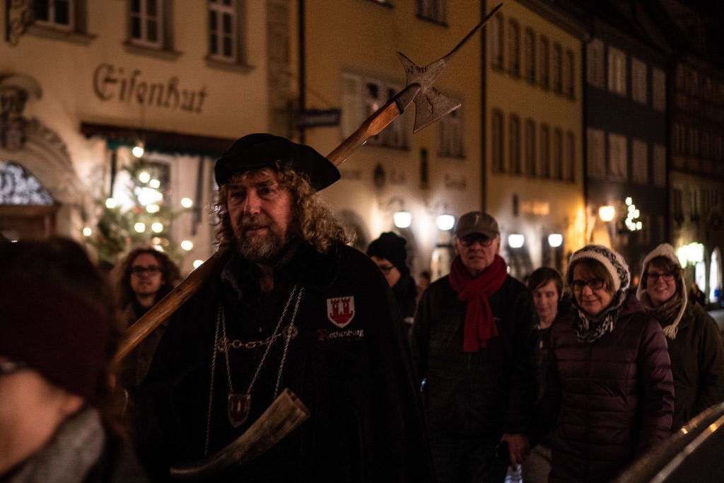 walking with group during night watchman tour in rothenburg germany