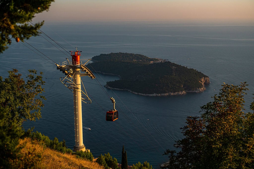 Cable car going up Mount Srd with Lokrum Island in the distance