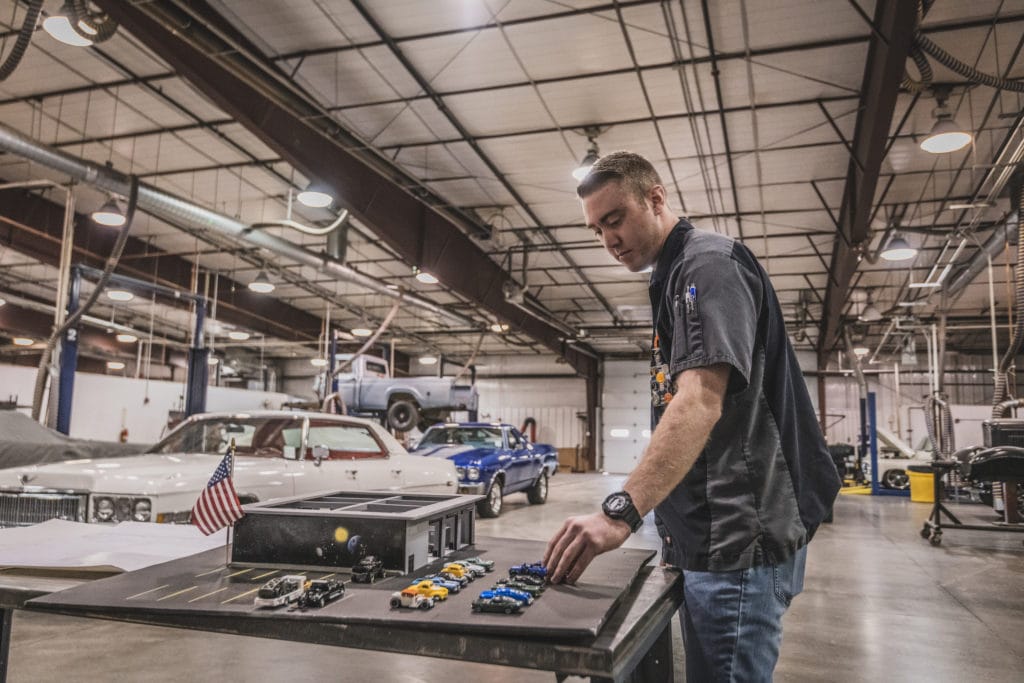 WyoTech team member in car garage