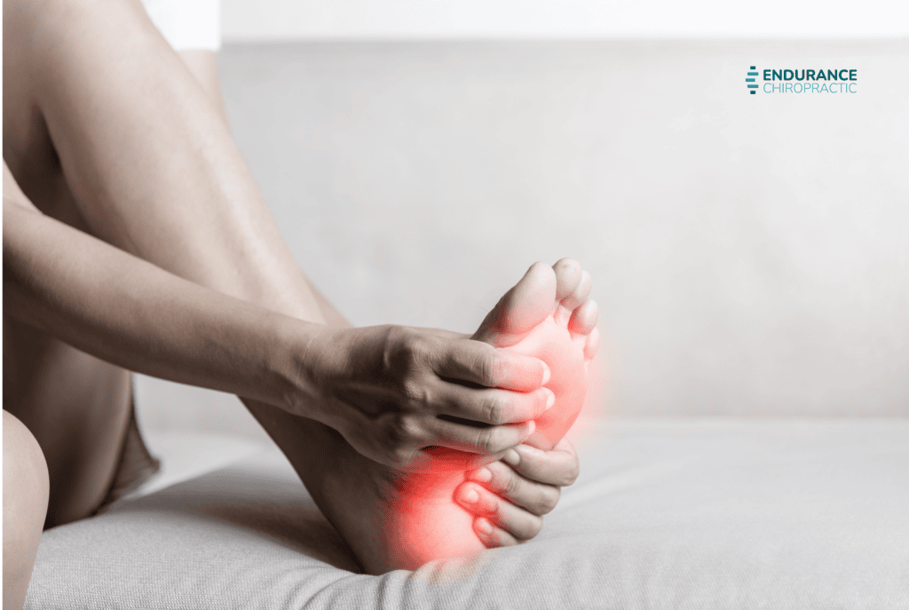 Person holding a painful heel with red highlight, representing plantar fasciitis and heel pain.