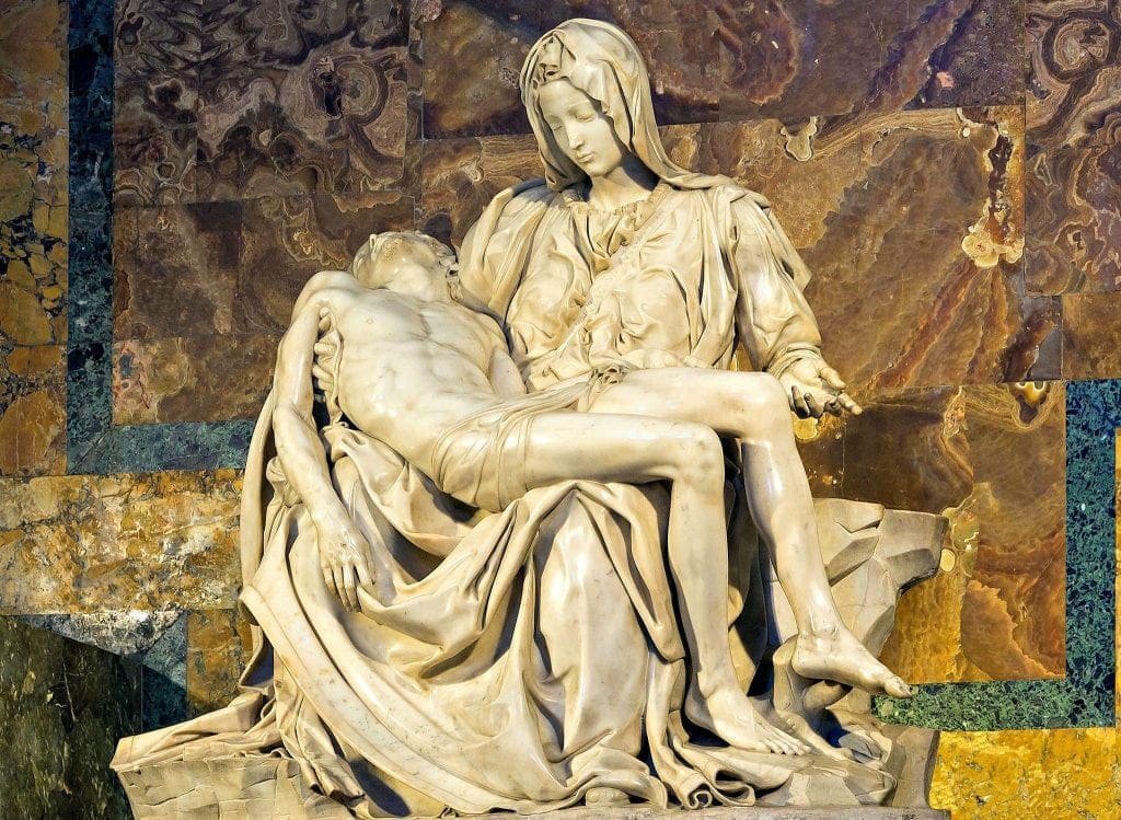 Creamy white marble statue of Mary, the mother of Christ, holding the body of her son on her lap. Meditating on sculptures help viewers with experiencing God through art and Encountering God through art