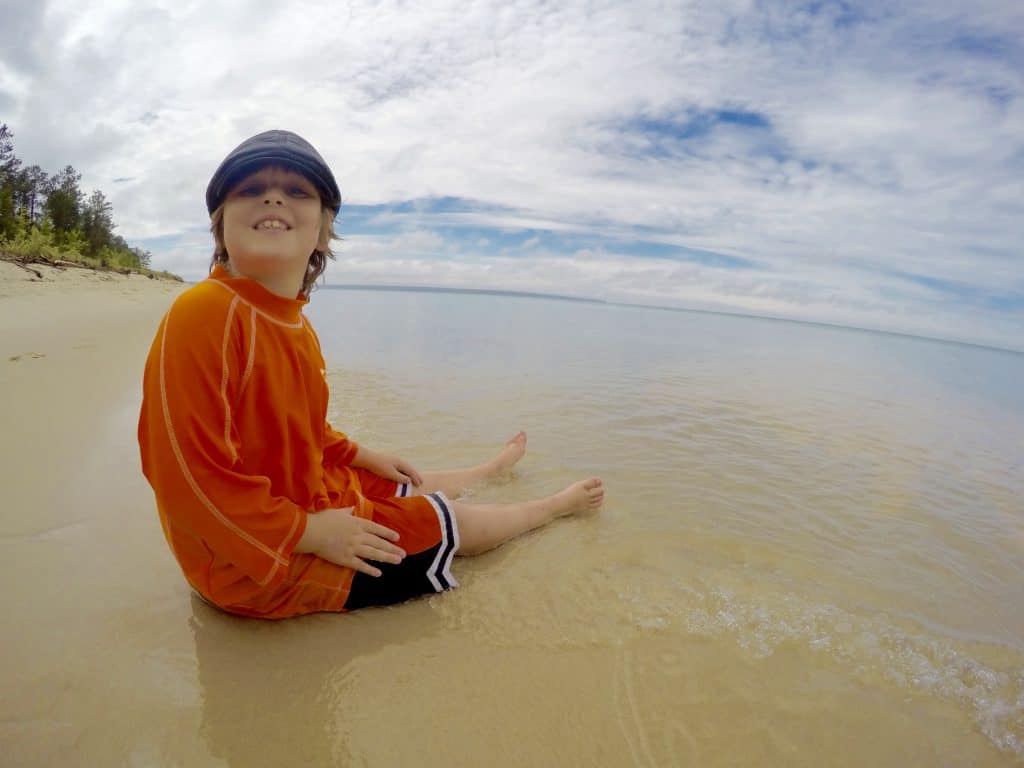 The Secret of Miner's Beach at Pictured Rocks National Lakeshore boy sitting on Miner's Beach in Michigan on Lake Superior