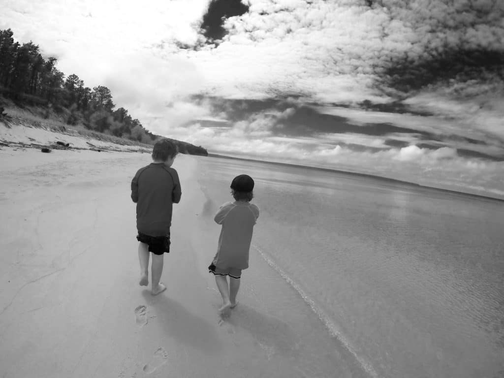 The Secret of Miner's Beach at Pictured Rocks National Lakeshore black and white photo of boys on Michigan beach